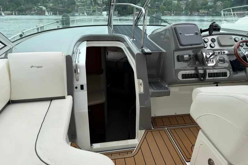 Slide: The Image of 2007 Cruisers 340 Express yacht cockpit with helm, seating, and cabin entrance. - 21