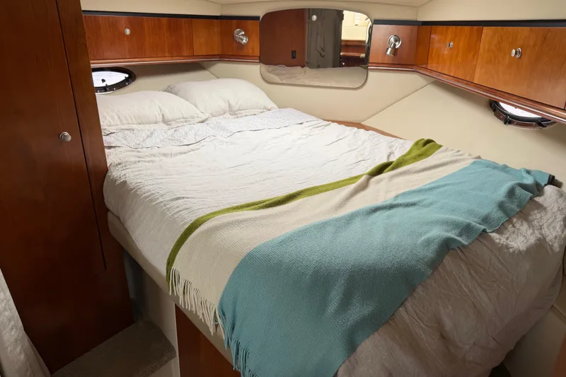 Slide: The Image of Luxurious cabin interior of 2007 Cruisers 340 Express yacht with cozy bed and wooden accents. - 28