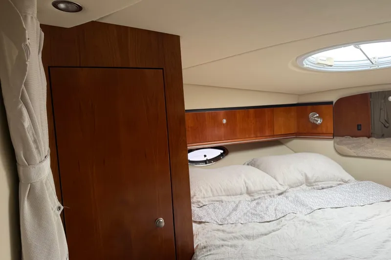 Slide: The Image of Luxurious cabin interior of 2007 Cruisers 340 Express yacht with cozy bedding and wooden accents. - 29