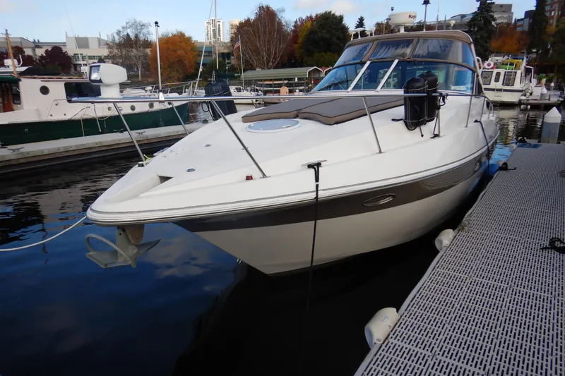 Slide: The Image of 2007 Cruisers 340 Express yacht docked at marina, surrounded by autumn foliage. - 3