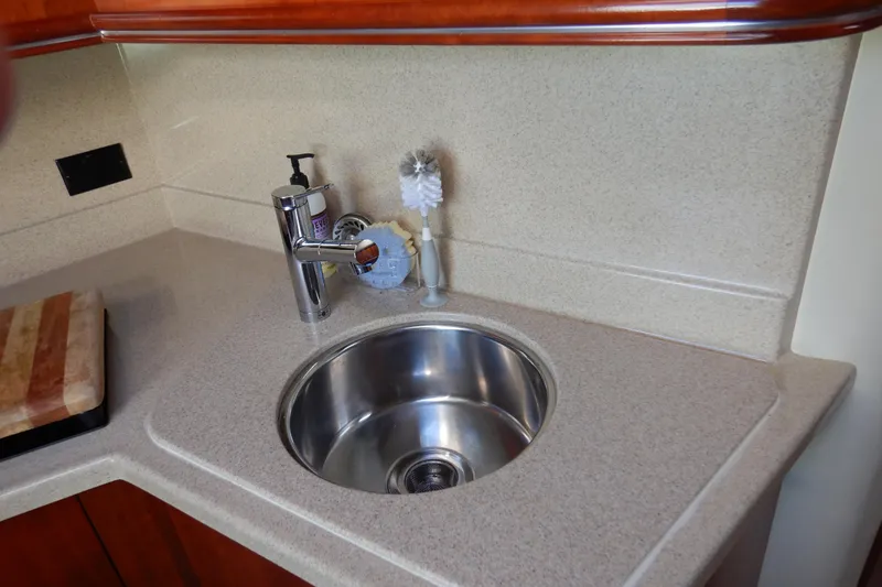 Slide: The Image of 2007 Cruisers 340 Express yacht kitchen sink with countertop and faucet. - 36