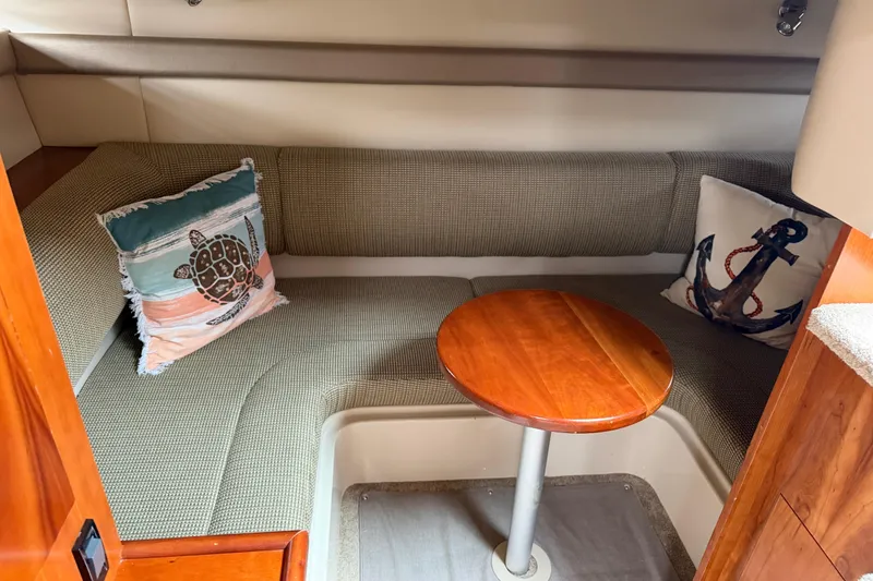 Slide: The Image of 2007 Cruisers 340 Express cabin interior with cozy seating and decorative pillows. - 38