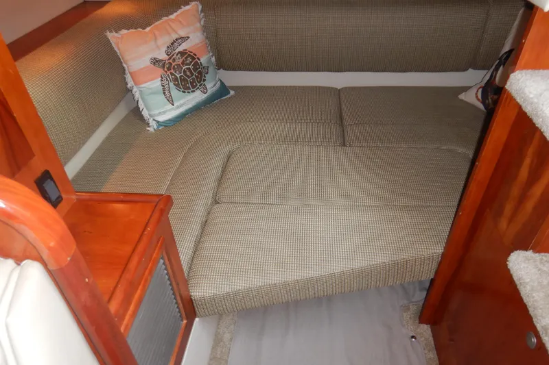 Slide: The Image of 2007 Cruisers 340 Express cabin interior with cushioned seating and decorative turtle pillow. - 39