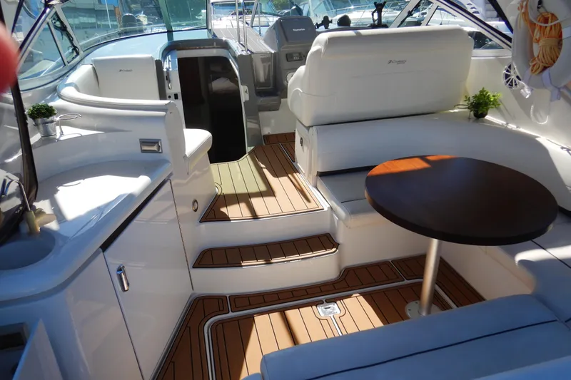 Slide: The Image of Luxurious 2007 Cruisers 340 Express yacht interior with white seating and wooden flooring. - 4