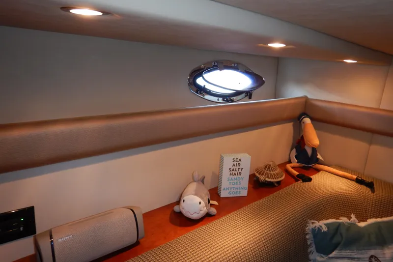 Slide: The Image of 2007 Cruisers 340 Express cabin interior with plush toys and decorative items. - 40