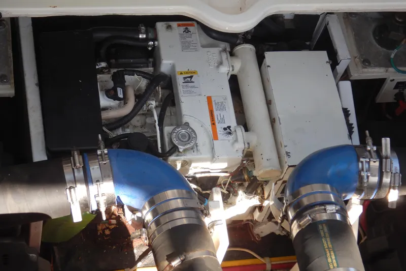 Slide: The Image of Engine compartment of a 2007 Cruisers 340 Express boat with visible hoses and components. - 52