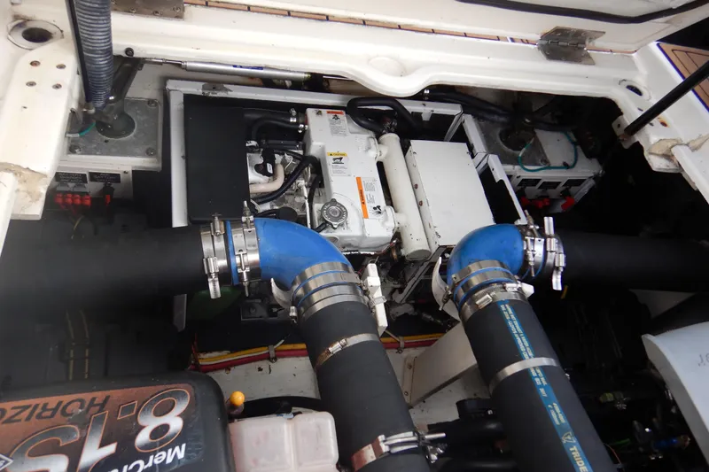 Slide: The Image of Engine compartment of a 2007 Cruisers 340 Express boat, featuring hoses and mechanical components. - 53