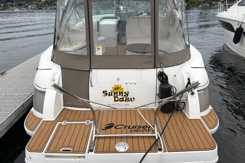 Slide: The Image of 2007 Cruisers 340 Express yacht docked, featuring teak deck and enclosed cockpit. - 55