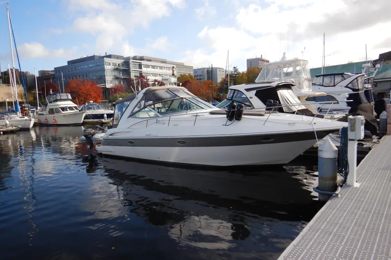 Slide: The Image of 2007 Cruisers 340 Express yacht docked in a marina with surrounding boats. - 63