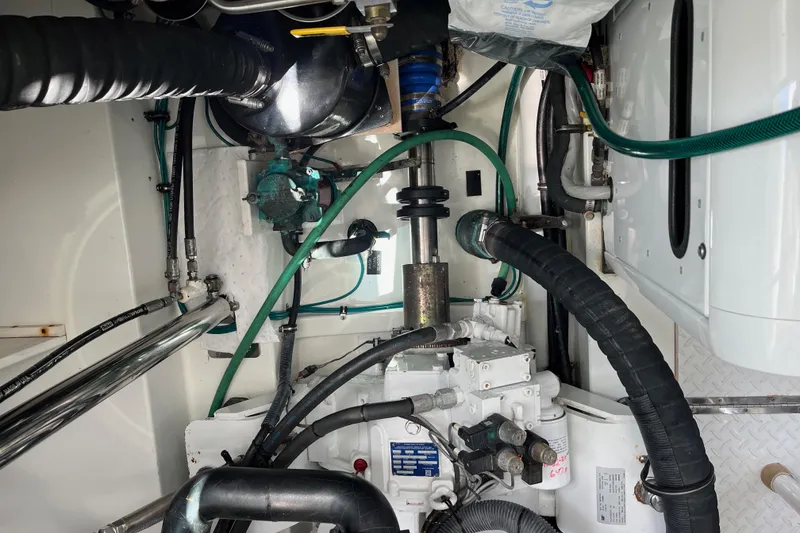 Slide: The Image of Engine room of a 2011 Rampage 41 Express boat with visible machinery and hoses. - 11