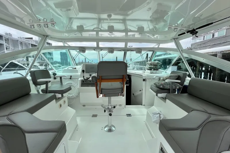 Slide: The Image of Interior view of a 2011 Rampage 41 Express boat with seating and helm station. - 12