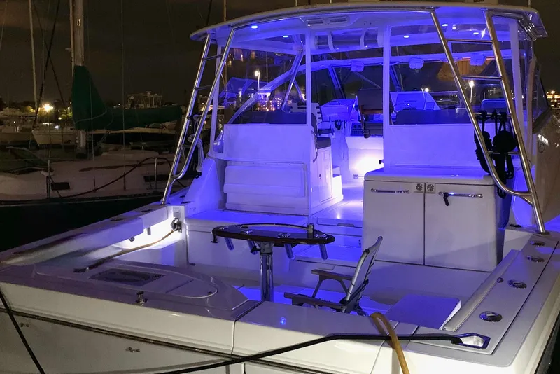 Slide: The Image of 2011 Rampage 41 Express boat with blue LED lighting at night in a marina. - 3
