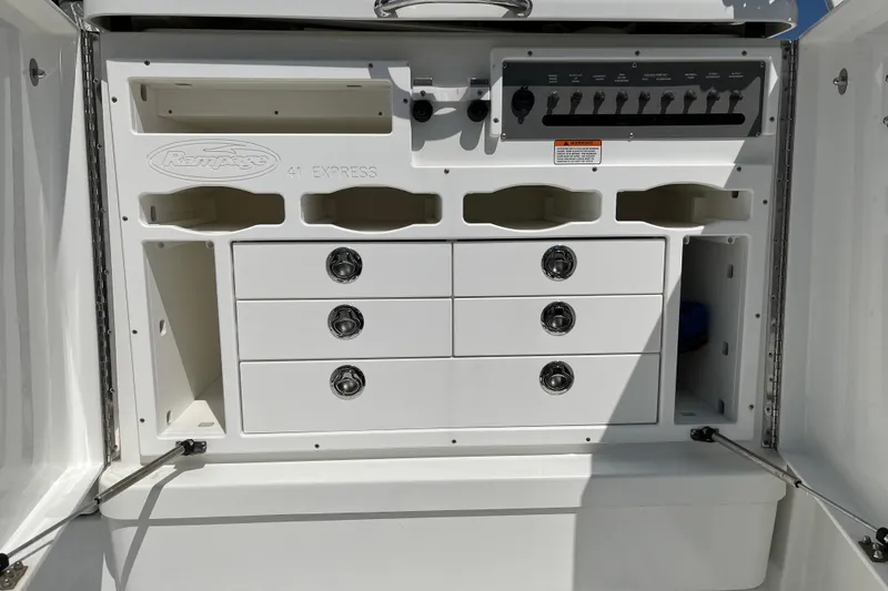 Slide: The Image of 2011 Rampage 41 Express boat storage compartment with drawers and control panel. - 7