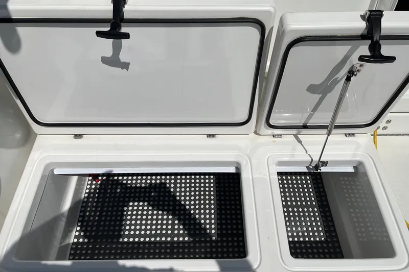 Slide: The Image of Open storage compartments on a 2011 Rampage 41 Express boat, featuring perforated interiors. - 8