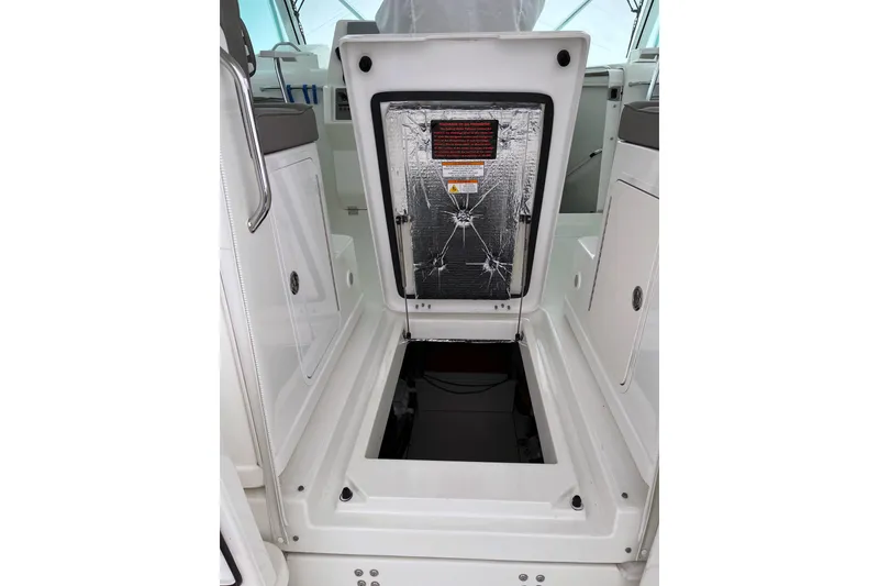 Slide: The Image of Open hatch on 2011 Rampage 41 Express boat, revealing storage compartment. - 9