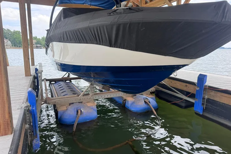 The Image of 2021 Sea Ray SPX 230 boat on lift, covered, docked by a lake. - 0