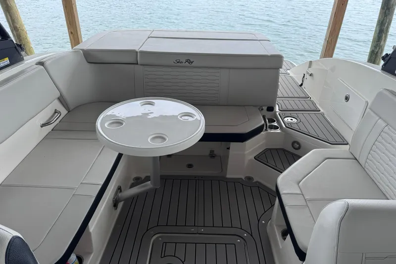 Slide: The Image of Interior of a 2021 Sea Ray SPX 230 boat with seating and table. - 12