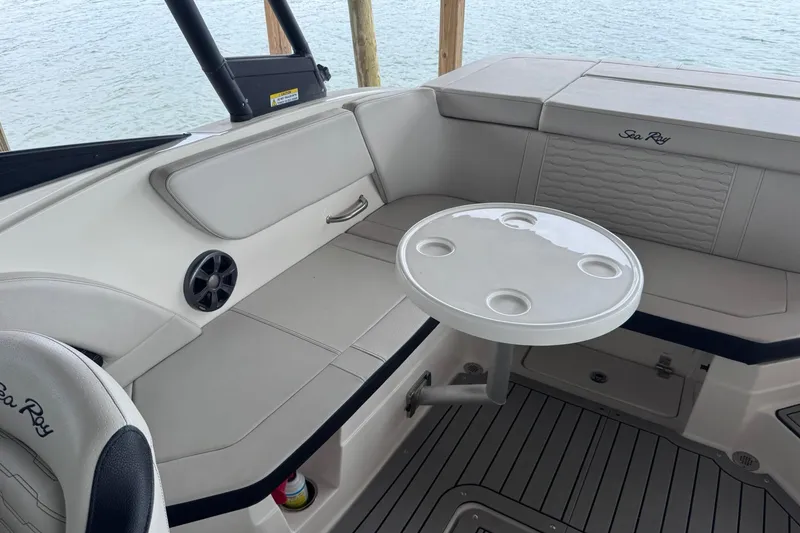 Slide: The Image of Interior of 2021 Sea Ray SPX 230 boat with seating and round table. - 13