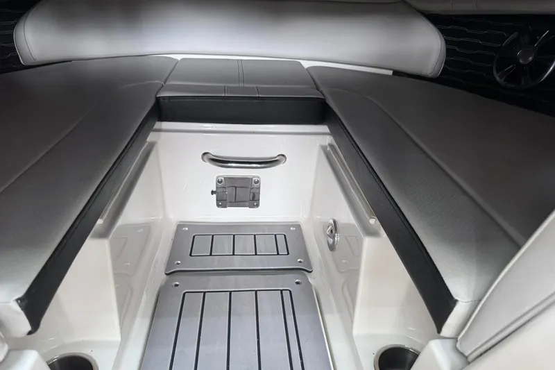 Slide: The Image of Interior of 2021 Sea Ray SPX 230 boat, featuring sleek seating and storage area. - 16