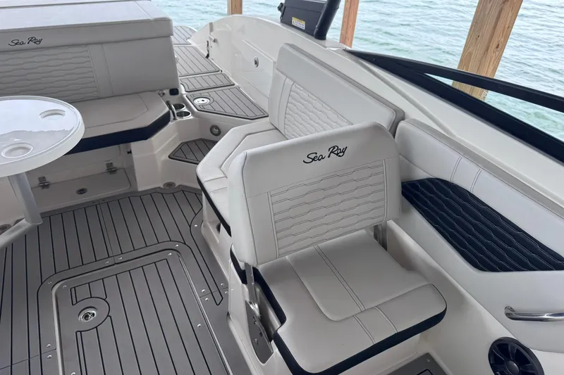 Slide: The Image of 2021 Sea Ray SPX 230 boat interior with white seating and sleek design. - 17