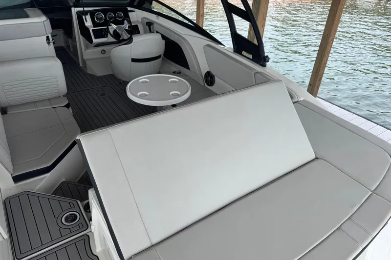 Slide: The Image of Interior of a 2021 Sea Ray SPX 230 boat with seating and steering wheel. - 20
