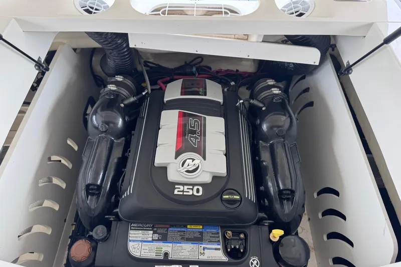Slide: The Image of Engine compartment of a 2021 Sea Ray SPX 230 boat, featuring a Mercury 4.5L 250 HP engine. - 24