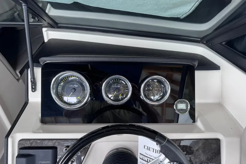 Slide: The Image of Dashboard of a 2021 Sea Ray SPX 230 boat with gauges and steering wheel. - 5