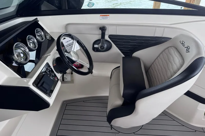 Slide: The Image of 2021 Sea Ray SPX 230 boat cockpit with steering wheel and gauges. - 6