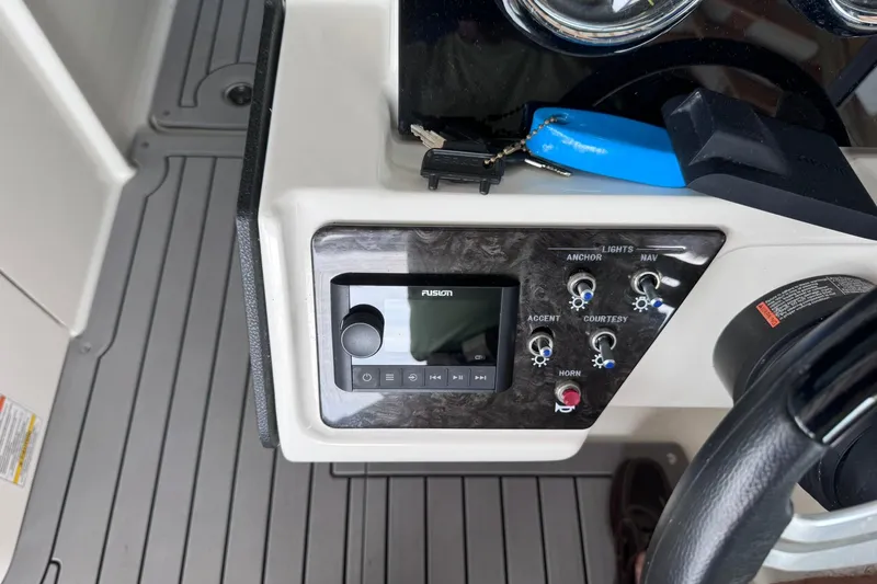 Slide: The Image of Control panel of a 2021 Sea Ray SPX 230 boat with audio system and switches. - 8