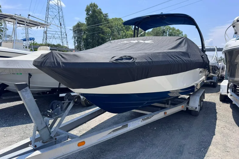 The Image of 2021 Sea Ray SPX 230 boat on trailer, covered, outdoors. - 0