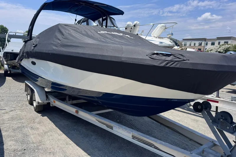 Slide: The Image of 2021 Sea Ray SPX 230 boat on trailer, covered, in outdoor storage. - 26