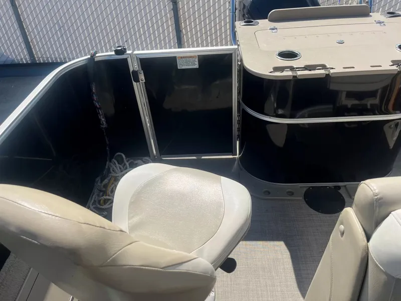 Slide: The Image of Interior of a 2015 Sylvan 8522 CNF with beige seats and black railing. - 14