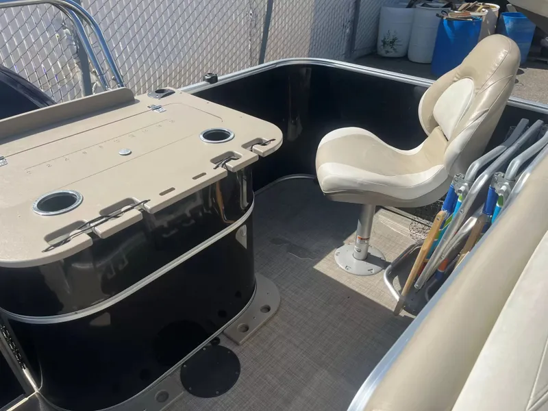 Slide: The Image of The image shows the cockpit of a 2015 Sylvan 8522 CNF with a beige seat and table. - 15