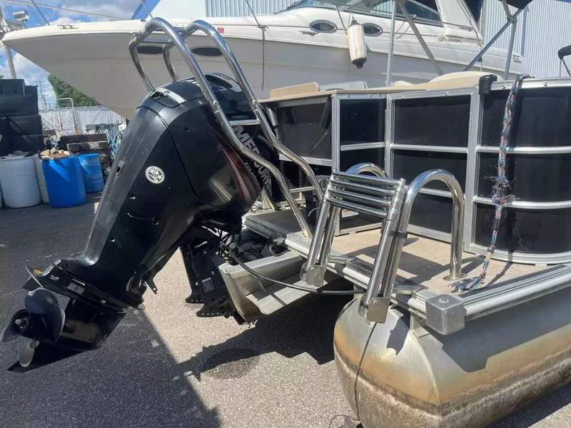 Slide: The Image of A 2015 Sylvan 8522 CNF pontoon boat with an outboard motor and swim ladder. - 22