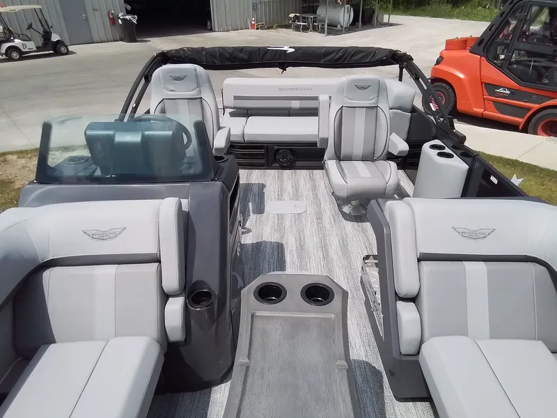 Slide: The Image of The image shows the interior of a Bennington 23M1SB pontoon boat with gray and white seating. - 12