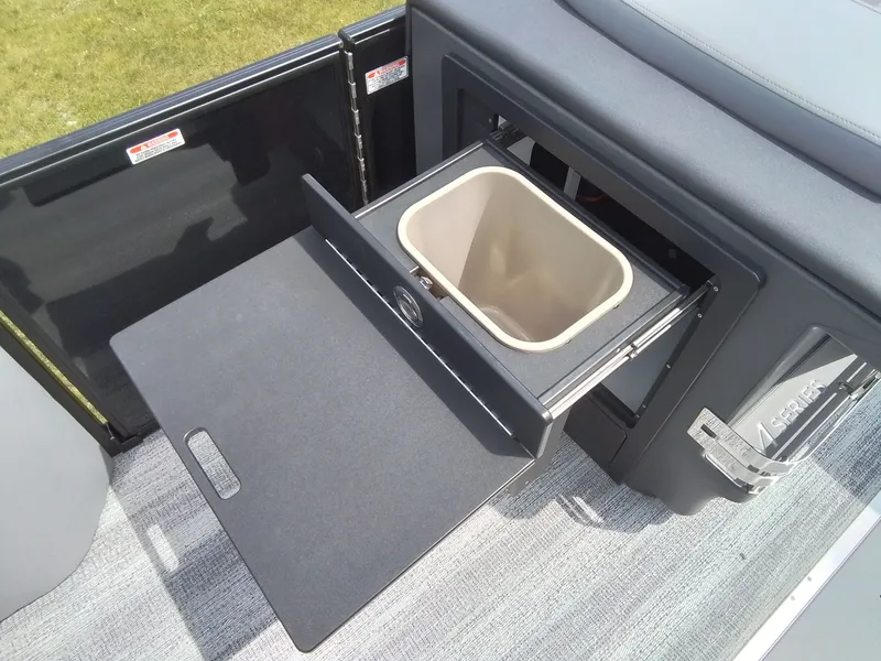 Slide: The Image of A pull-out trash bin in a boat, surrounded by gray carpeting. - 17