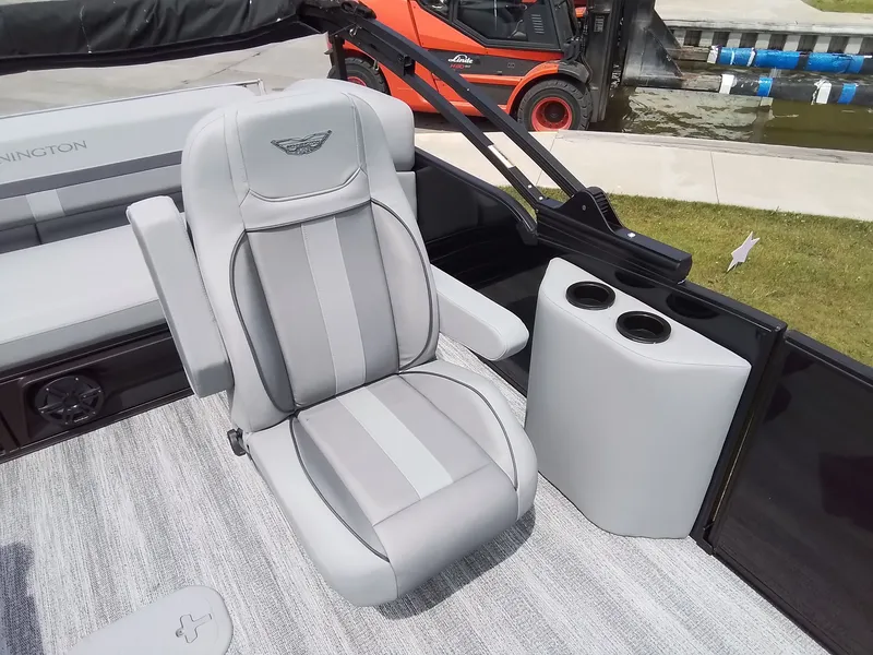 Slide: The Image of A luxurious gray seat on a Bennington boat, featuring cup holders and a sleek design. - 19