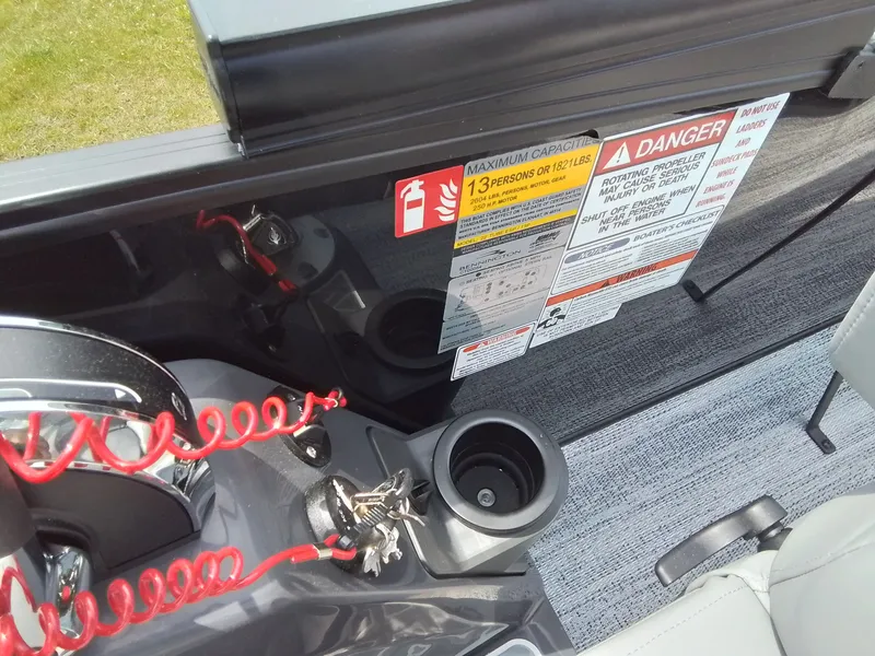 Slide: The Image of Close-up of a boat console with safety warnings and cup holders. - 32