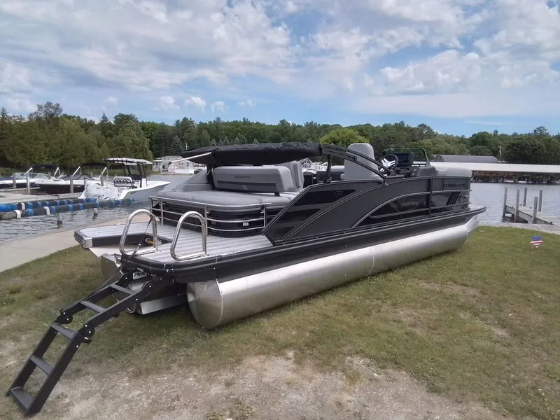 Slide: The Image of 2026 Bennington 23M1SB pontoon boat on grass near a lake. - 5