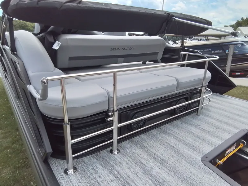 Slide: The Image of The image shows the rear of a Bennington 23M1SB pontoon boat with gray seating and stainless steel railing. - 9