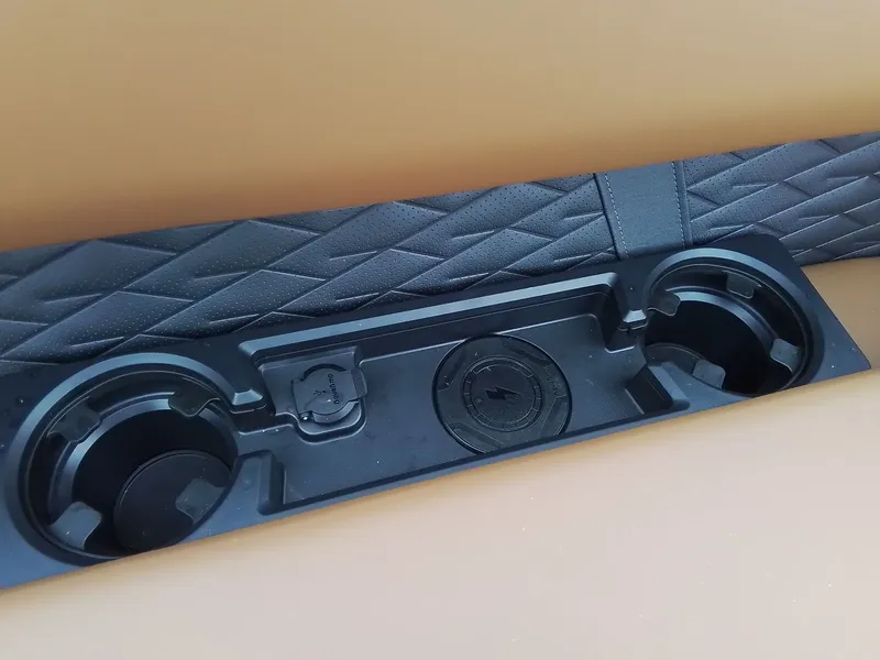 Slide: The Image of Close-up of a cup holder on a boat with cushioned seating. - 13