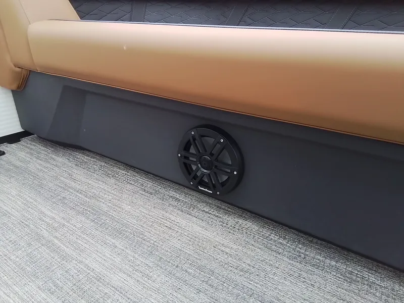 Slide: The Image of A speaker is embedded in the side panel of a boat, surrounded by cushioned seating. - 14