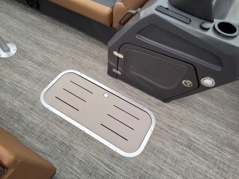 Slide: The Image of Floor hatch on a boat with gray carpet and brown seating. - 15