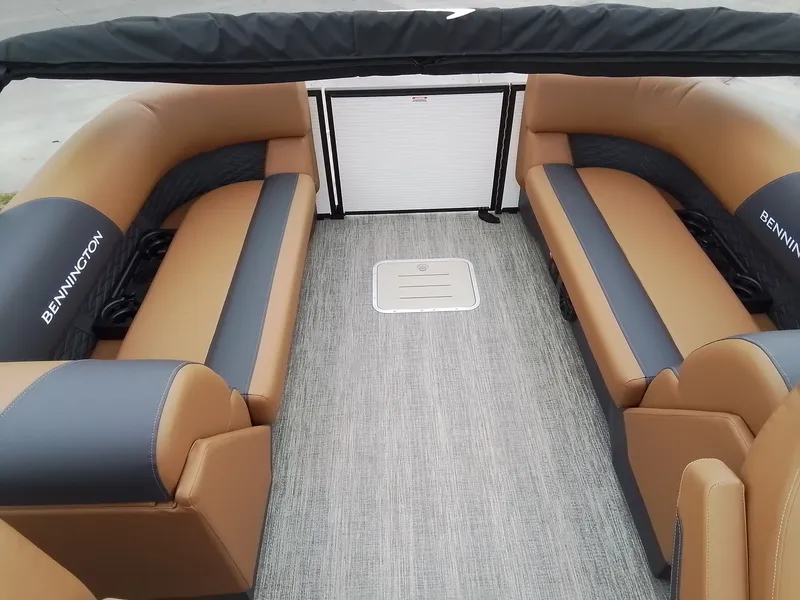Slide: The Image of Interior of a Bennington 23SSRSF pontoon boat with beige and black seating. - 17