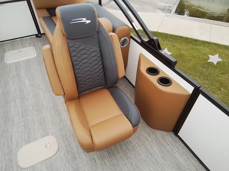 Slide: The Image of A luxurious seat on a Bennington 23SSRSF boat, featuring brown and gray upholstery. - 19