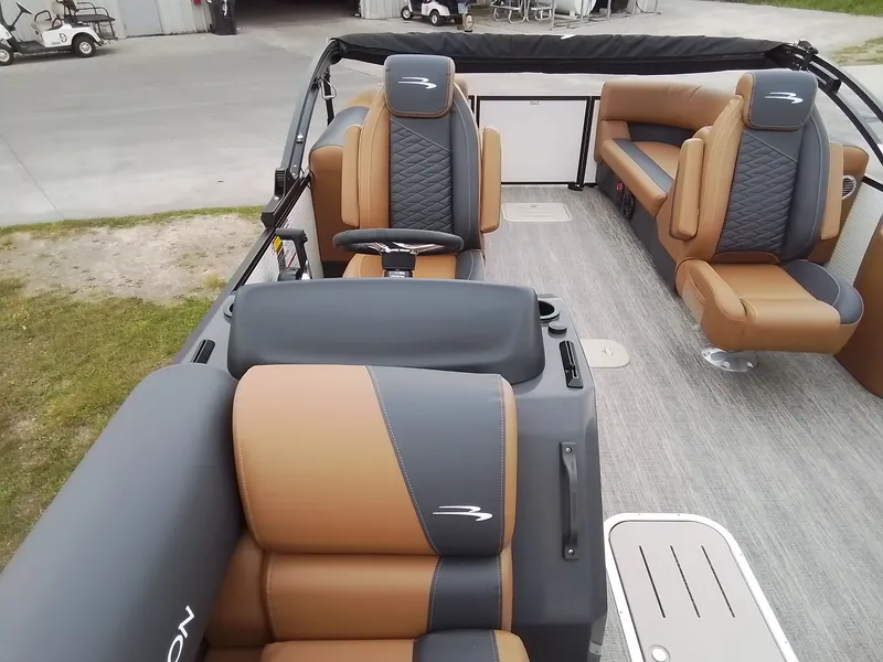 Slide: The Image of Interior of a Bennington 23SSRSF boat with luxurious brown and gray seating. - 20