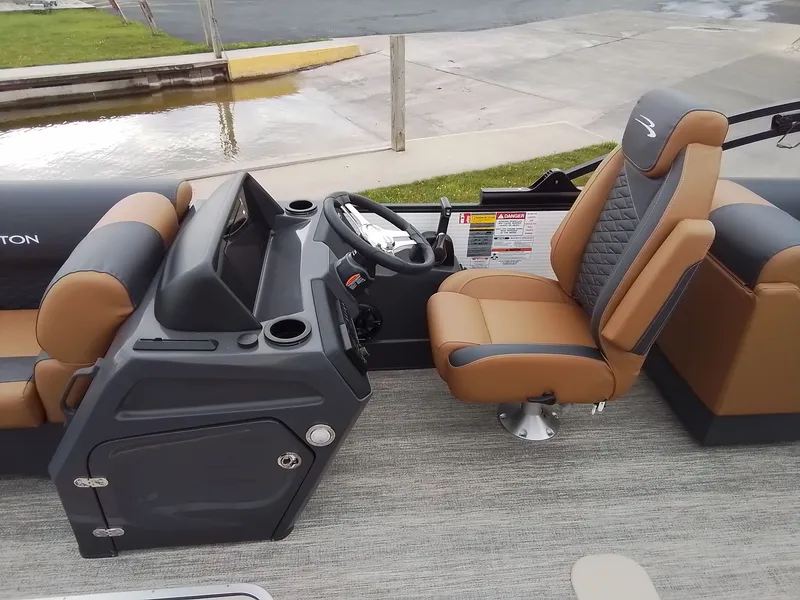Slide: The Image of The image shows the cockpit of a Bennington 23SSRSF boat with a comfortable helm seat. - 21