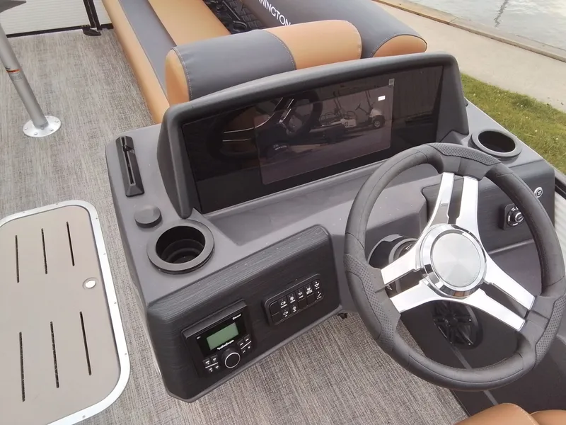 Slide: The Image of The image shows the helm of a 2026 Bennington 23SSRSF boat with a modern steering wheel. - 23