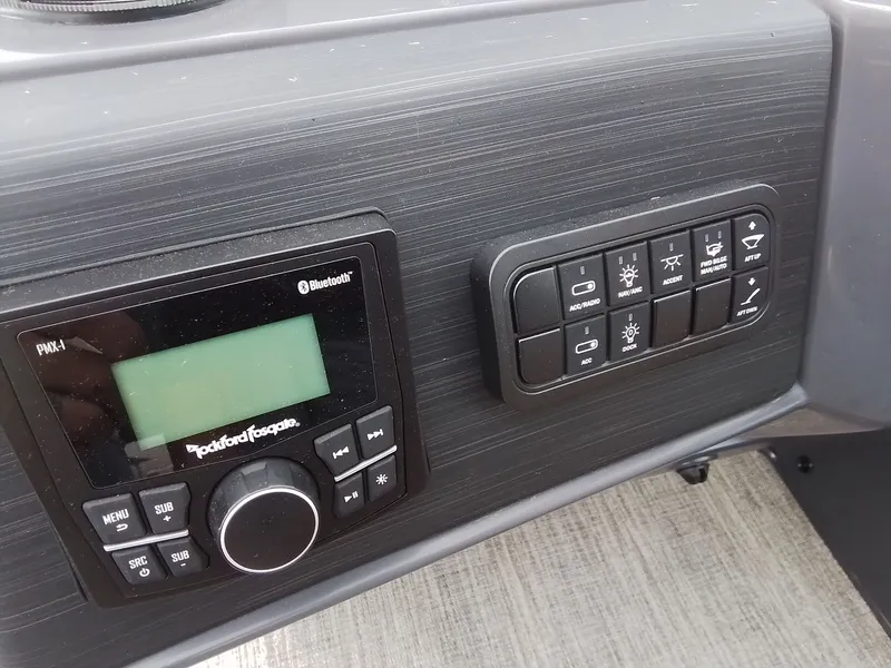Slide: The Image of The image shows a boat panel with a radio and several switches. - 24