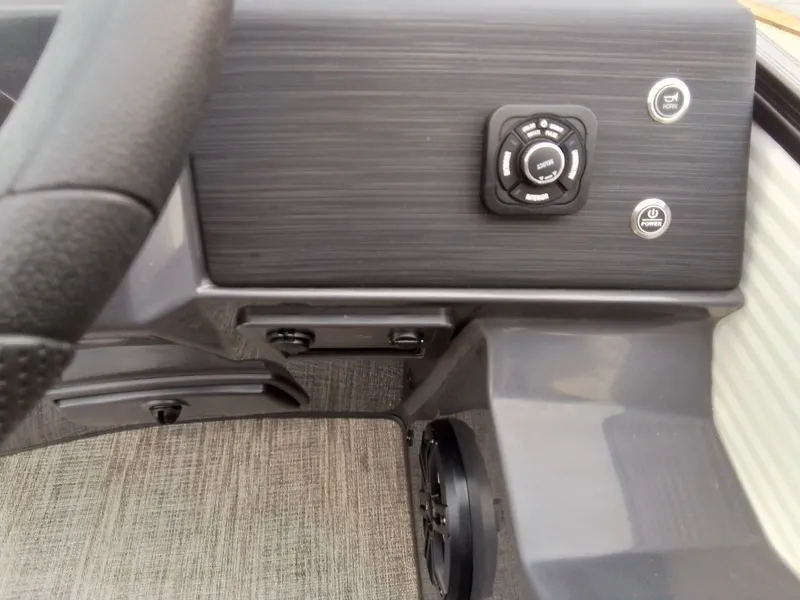 Slide: The Image of Close-up of a boat's helm area with controls and steering wheel. - 25